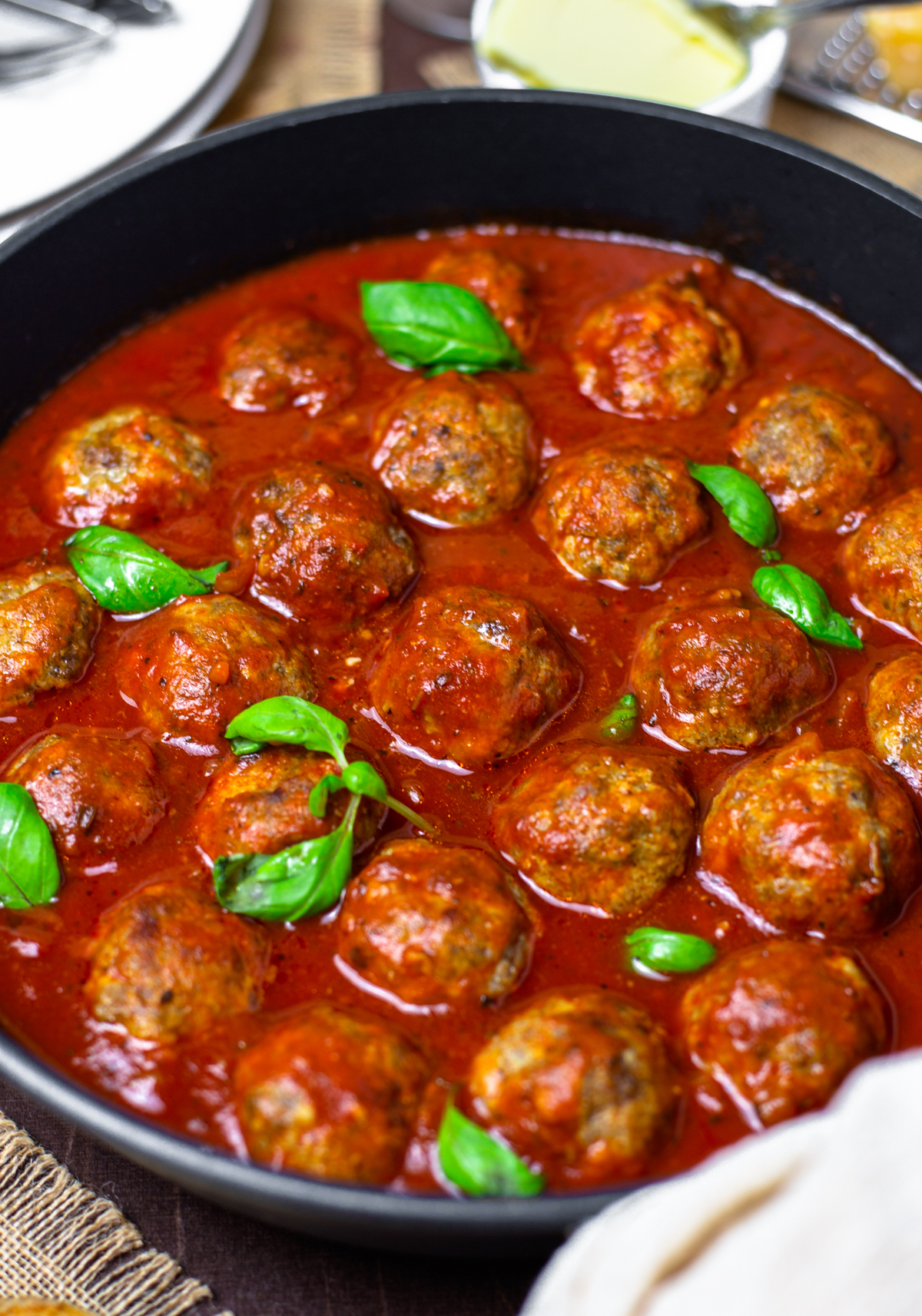 Close up of Homemade Meatballs in sauce with basil pieces