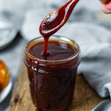Spoon dripping Homemade BBQ Sauce Recipe in jar
