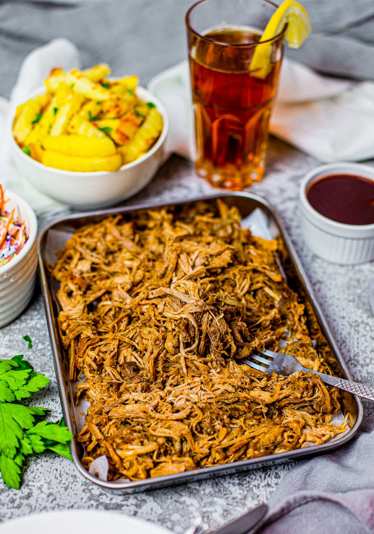 Crock Pot Pulled Pork on tray with form and French fries in bowl