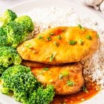 Two pieces of Slow Cooker Ginger Chicken on plate with rice and broccoli.