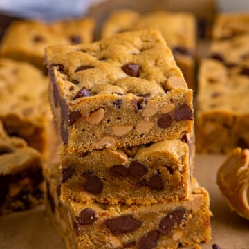 Three stacked Peanut Butter Chocolate Chip Cookie Bars.