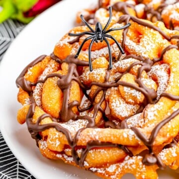 Close up of Crisp Spider Webs with chocolate and powdered sugar and spider.