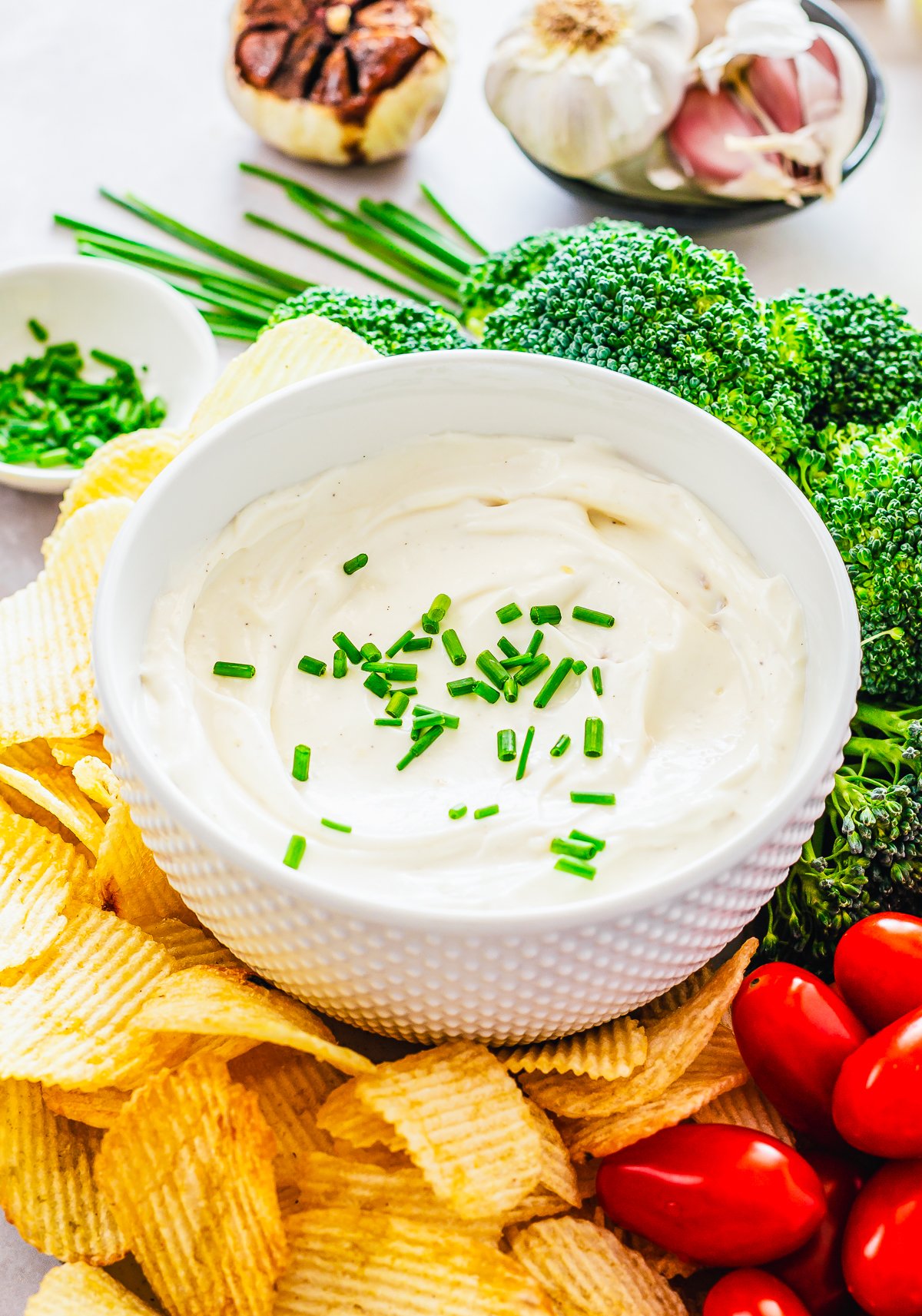 Close up of bowl of Garlic Cream Cheese Dip garnished with chives.
