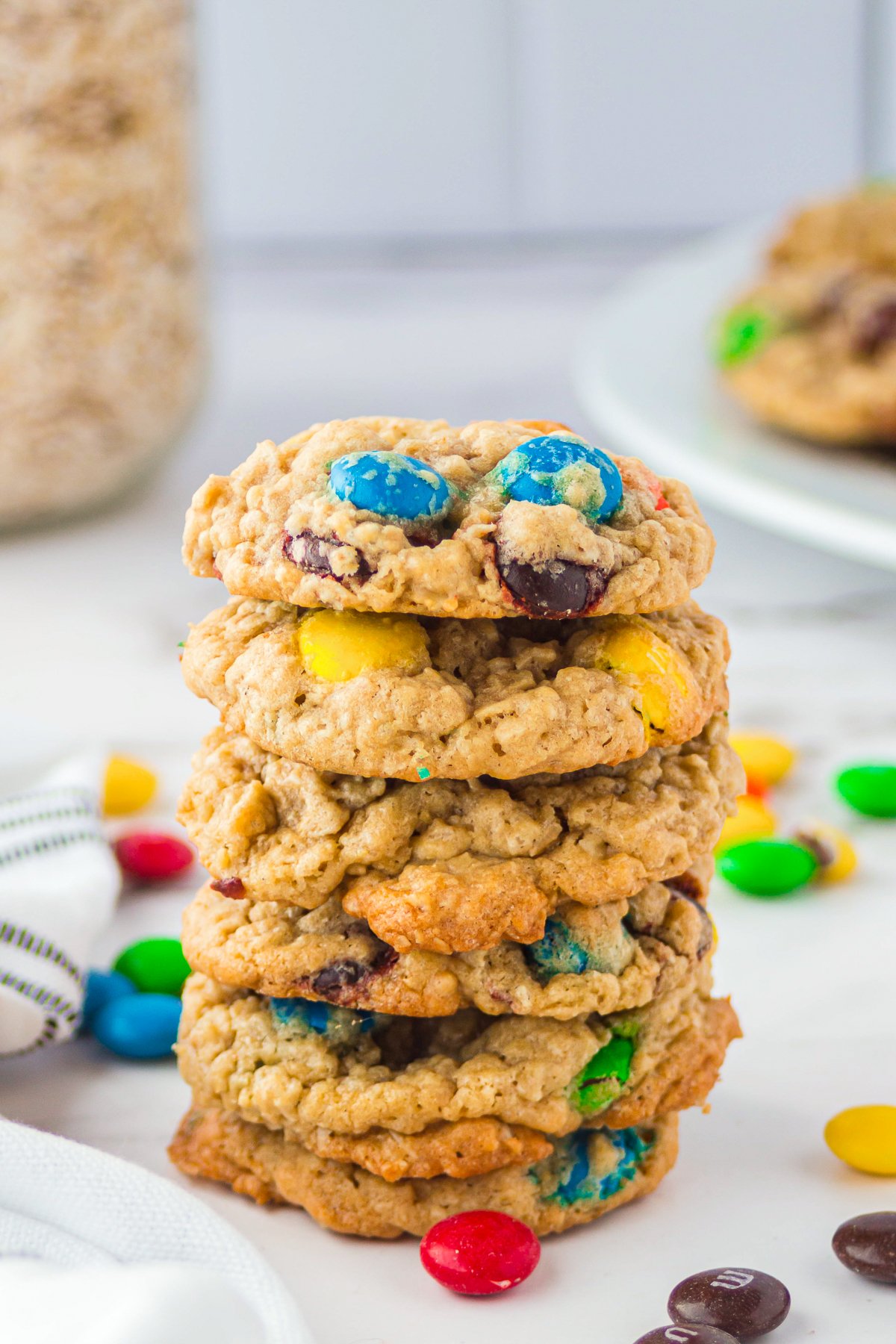 M&M Oatmeal Cookies stacked on top of one another.