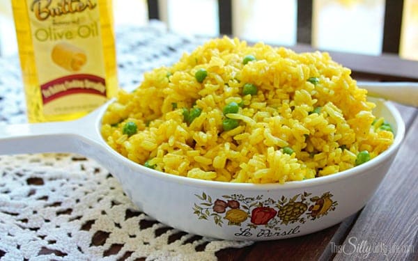 A serving of yellow rice with peas plated and ready to enjoy as an easy side dish.