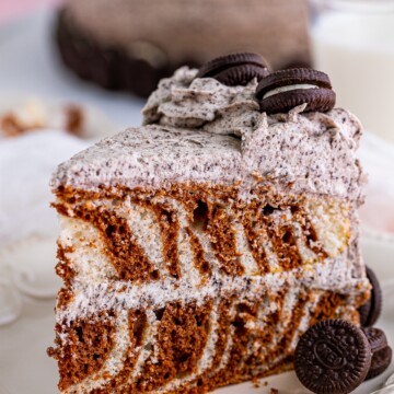 One slice of the Zebra Cake Recipe on white plate showing the stripes.