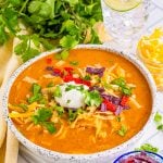 Copycat Chili's Enchilada Soup finished in bowl with toppings.