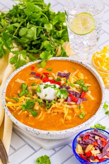 Copycat Chili's Enchilada Soup finished in bowl with toppings.