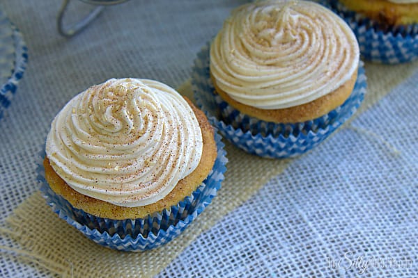 Cinnamon Sugar Cupcakes, yellow cake studded with cinnamon chips, brushed with butter and rolled in cinnamon sugar, topped with the BEST cream frosting!
