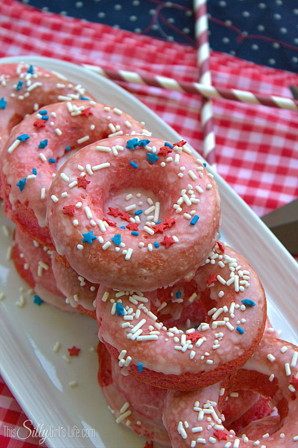 Baked Strawberry Cake Doughnuts, cake doughnuts baked and dipped in a thin vanilla glaze, garnished with festive sprinkles!