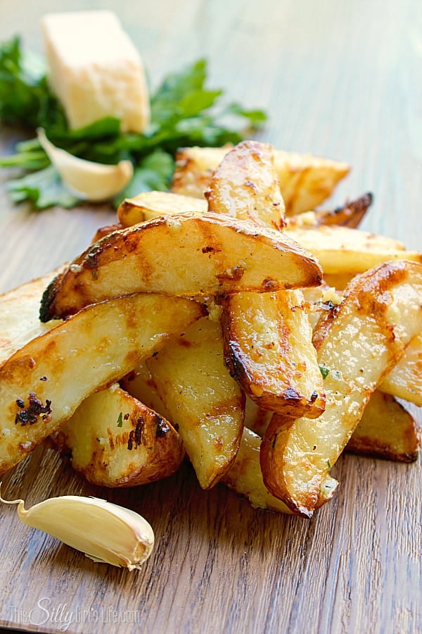 Garlic Parmesan Grilled Potato Wedges, baked then grilled and tossed in a flavorful garlic Parmesan butter sauce. Perfect for warm summer night dinners!