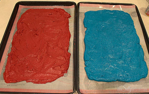 Spread each different color dough onto a parchment lined cookie sheet to 1/2 inch thick.