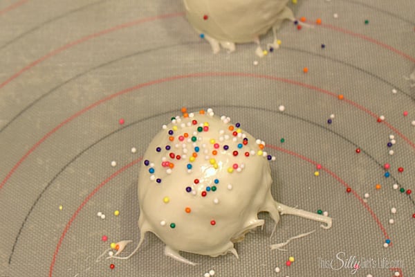 Place on a silicone mat or parchment paper, gently sliding them off the fork with a skewer. Immediately garnish with sprinkles so they stick to the candy before it hardens.