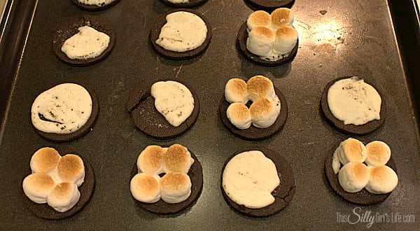 Take the oreo and carefully half them. On the side with less cream, place four mini marshmallows. Under the broiler in the oven, toast the marshmallows watching the whole time this will take about 20 seconds. Let marshmallows cool and place a teaspoon full of vanilla ice cream on top of marshmallows. Top with other half of oreo and very gently press down. Place in the freezer for 30 minutes to set up. 