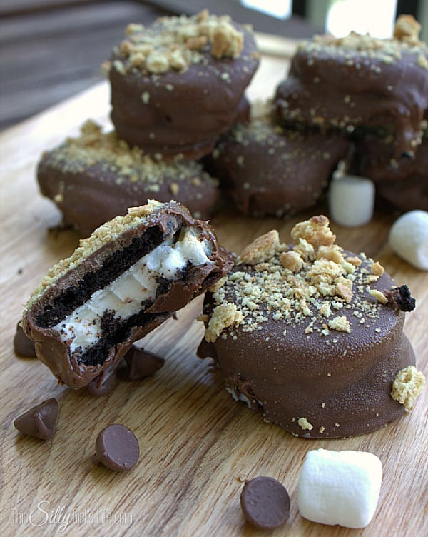 Toasted marshmallows and ice cream sandwiched between Oreo cookies, dipped in chocolate with a graham cracker garnish... insane!