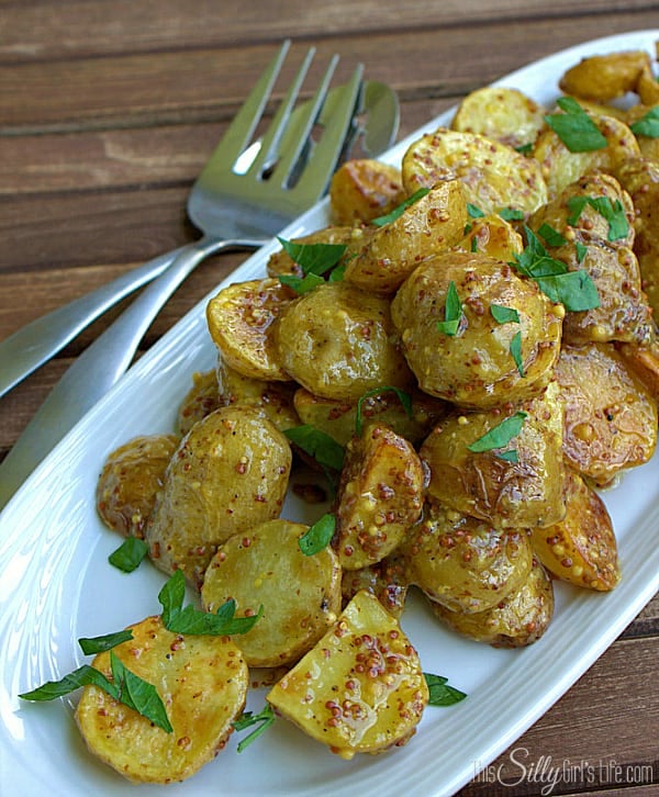 French Style Roasted Potato Salad, baby yellow potatoes roasted at high heat, tossed in a flavorful whole mustard dressing and garnished with fresh parsley.