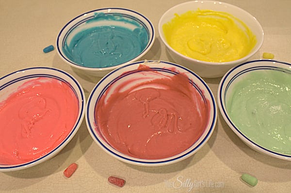 Preheat oven to directions on back of cake mix packaging. Mix the eggs, oil, 1 Cup water and cake mix until smooth on medium speed about 2 minutes with hand mixer. Divide the cake batter into 5 separate bowls. It makes about 5 perfect cups of batter. Using food coloring, color each bowl according to the colors of the Zours. I kept each one of the Zours out to try and match the color as close as I could. 