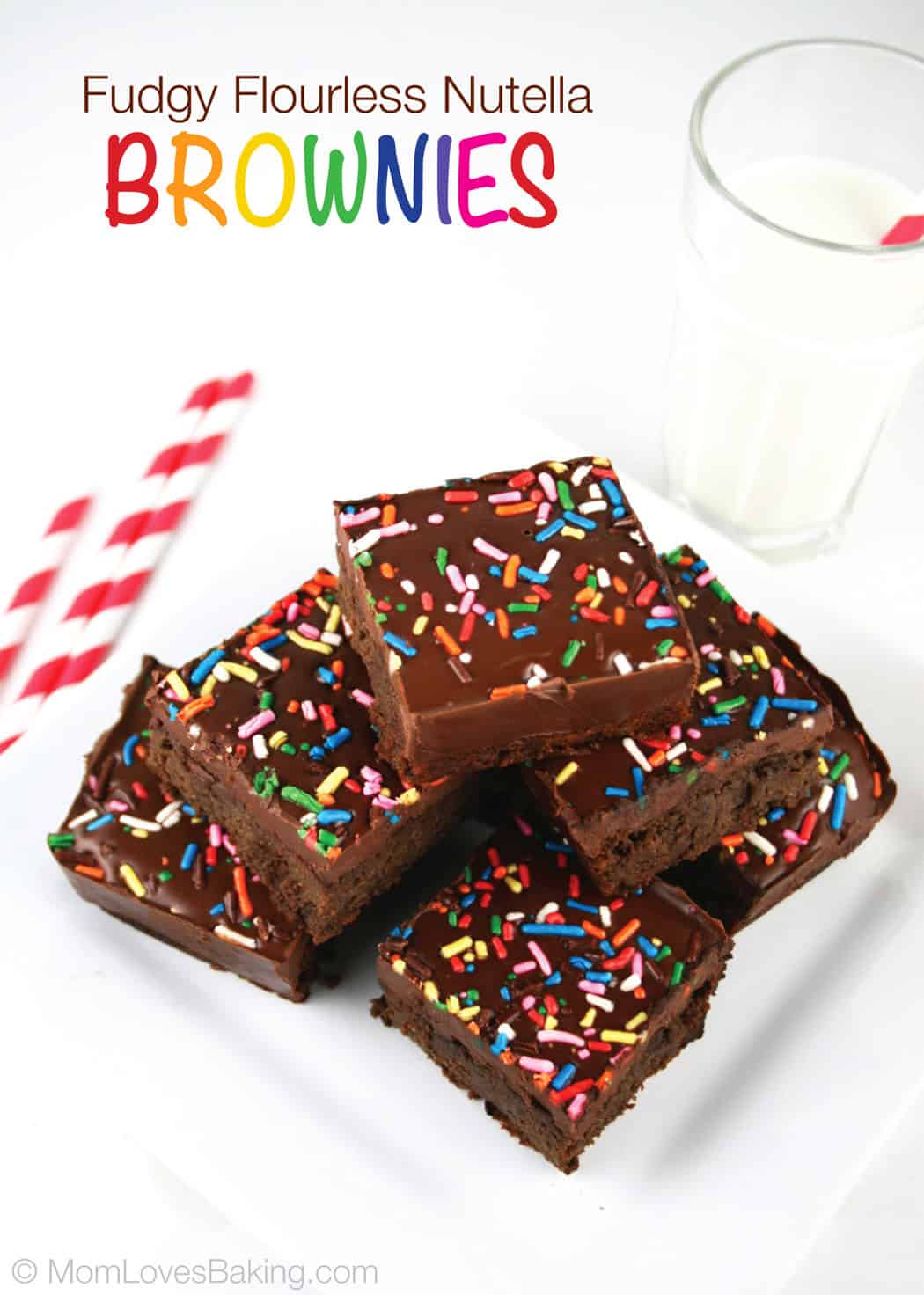 Fudgy black bean brownies topped with chocolate frosting and rainbow sprinkles stacked next to a glass of milk.