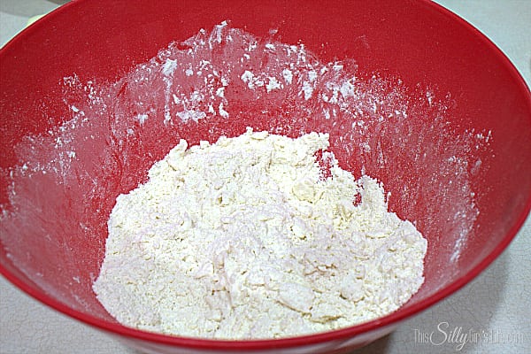 Preheat oven to 400 degrees. Place flour, baking powder, salt and sugar in a bowl. Mix until combined. Place chopped butter in the flour mixture. Toss to coat butter in flour. Using your fingers, rub the butter with your finger tips until it breaks down and everything looks like coarse sand. Add in the goat cheese and repeat. 