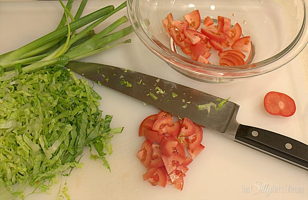Slice lettuce, tomato and scallions.