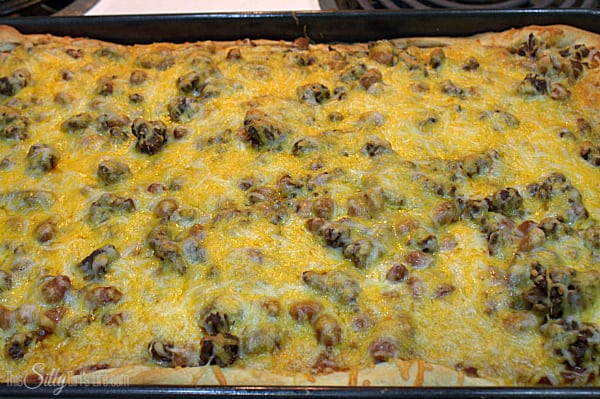 bake for an additional 10 minutes or per the directions on the back of the pizza crust can, until the cheese is bubbly and the crust is golden brown. 