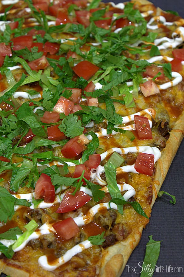 Easy Taco Pizza, two favorites combine to make a delicious, easy meal that's ready in 30 minutes or less! - https://ThisSillyGirlsLife.com