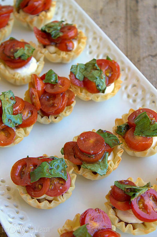 Creamy Bruschetta Bites, Parmesan cream cheese piped into phyllo cups and topped with tomato basil bruschetta! - ThisSillyGirlsLife.com