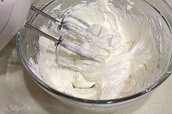 Place the cream cheese in a large bowl and with a hand mixer, cream it on medium speed. Add in the marshmallow creme and mix to combine. 