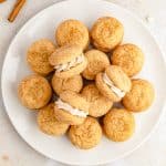 A platter of soft snickerdoodle sandwich cookies filled with white chocolate cinnamon frosting.
