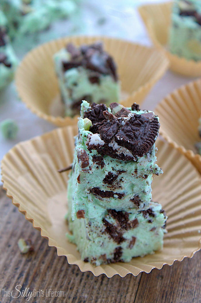 Mint Fudge Recipe stacked on brown paper liners.