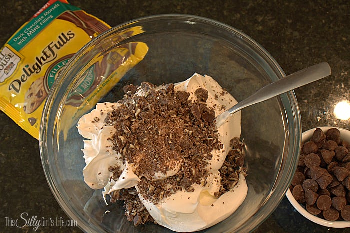 Mint Cookies and Cream Bomb Cake, an easy layered dessert loaded with mint chocolate morsels and Oreos! - ThisSillyGirlsLife.com #TollHouseTime #NestleTollHouse #DelightFulls #sp
