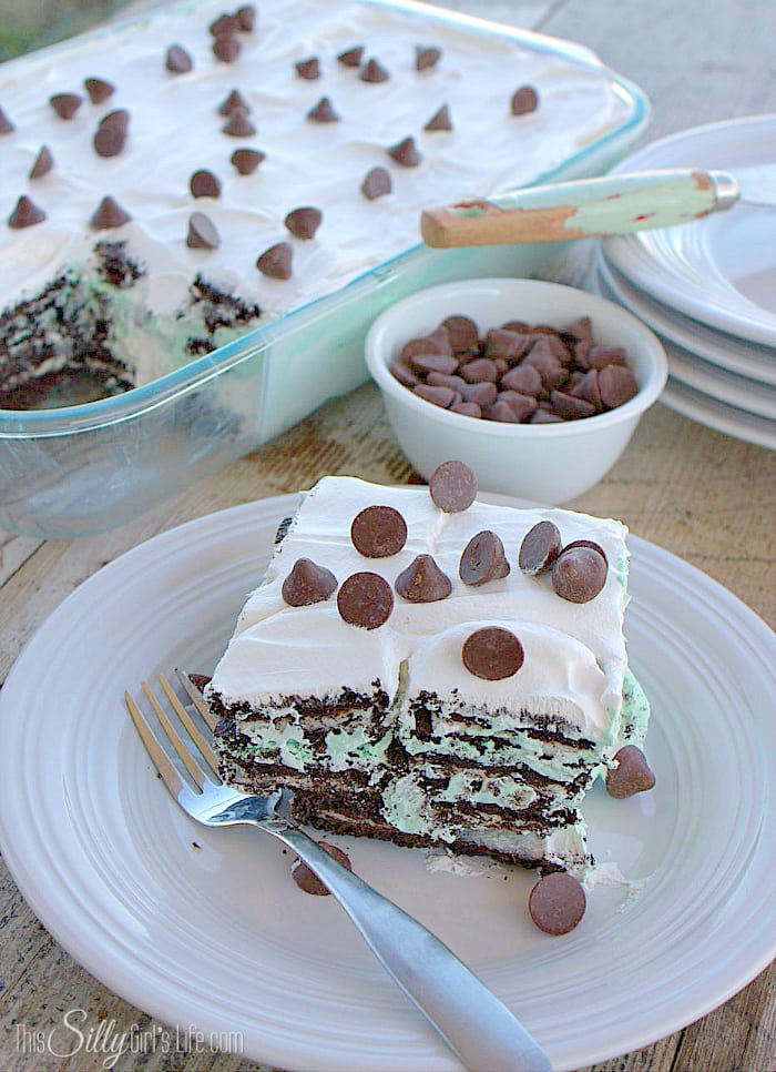 Mint Cookies and Cream Bomb Cake, an easy layered dessert loaded with mint chocolate morsels and Oreos! - ThisSillyGirlsLife.com #TollHouseTime #NestleTollHouse #DelightFulls #sp
