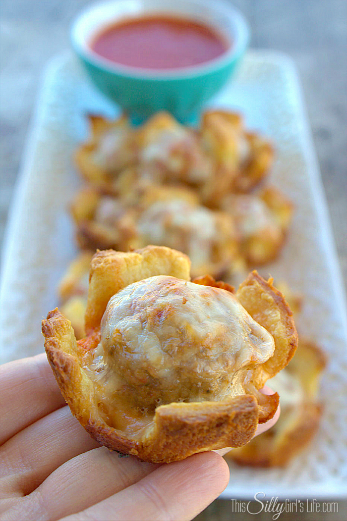 Meatball Sub Cups, meatballs and provolone cheese baked in crescent roll cups. Served with tomato sauce, a great party appetizer, yum! - ThisSillyGirlsLife.com #MancinisMeatballs #ad