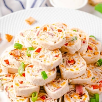 Stacked Cheddar Bacon Ranch Pinwheels on white plate.