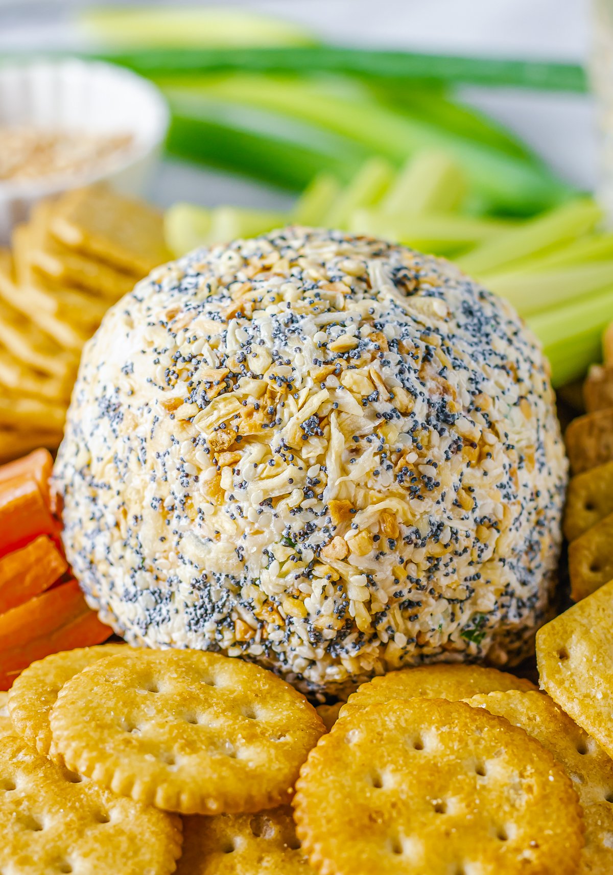 Finished Cheese Ball Recipe surrounded by dippers. 