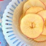 A bowl of crispy homemade baked apple chips made from thinly sliced honeycrisp apples.