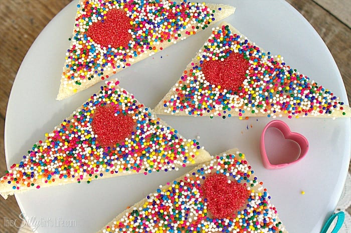 Cupid Fairy Bread, white bread smeared with homemade honey butter and topped with sprinkles for a yummy Valentine's day snack! - ThisSillyGirlsLife.com #ValentinesDayDesserts #FairyBread