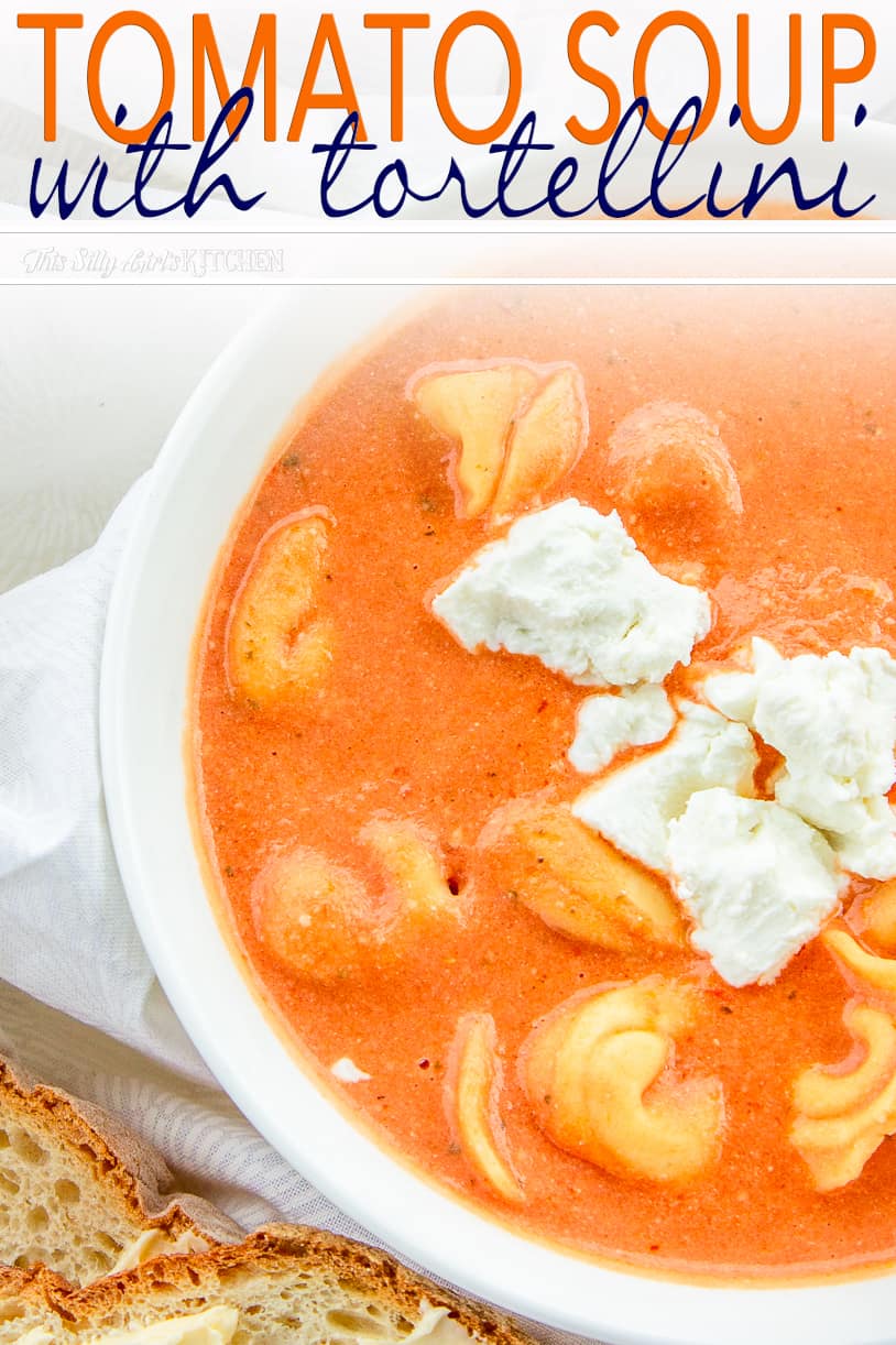 Close up of bowl The Best Tomato Soup Recipe topped with goat cheese Pinterest Image