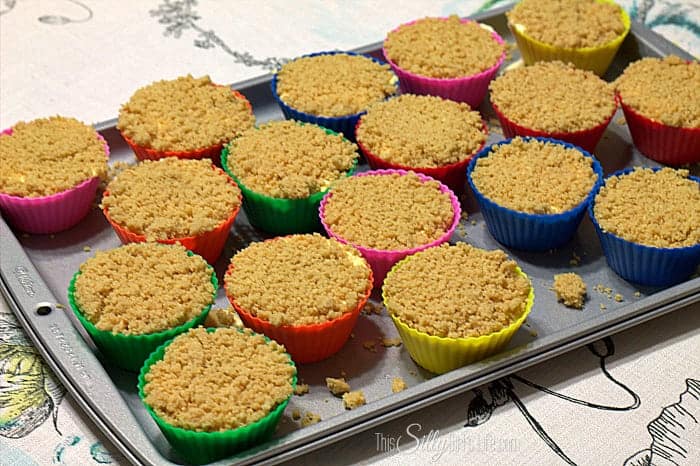 Vanilla cookie crumb topping pressed over the filled Orange Creamsicle Pie cups.