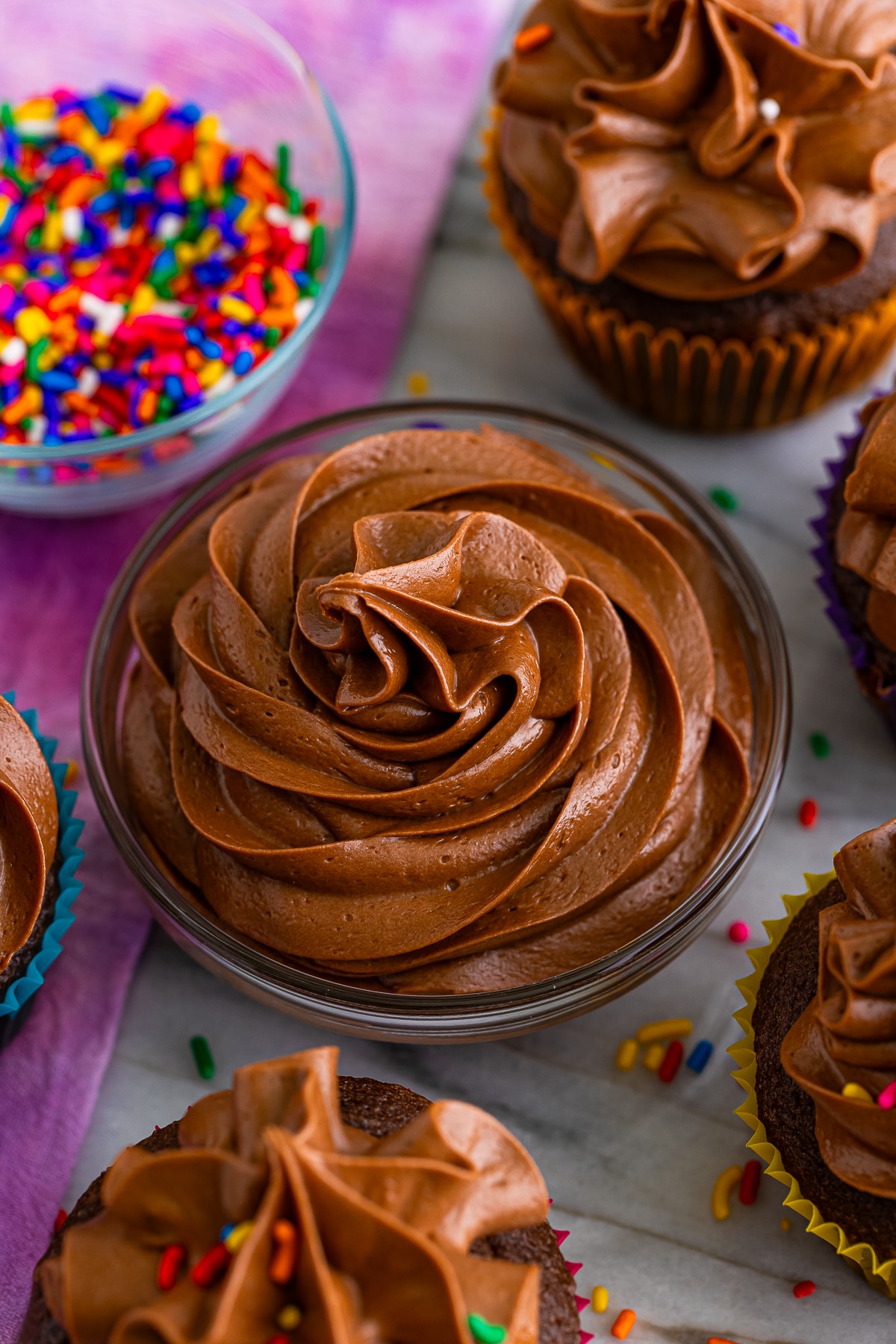 overhead image of Chocolate Buttercream Frosting piped in a small glass bowl