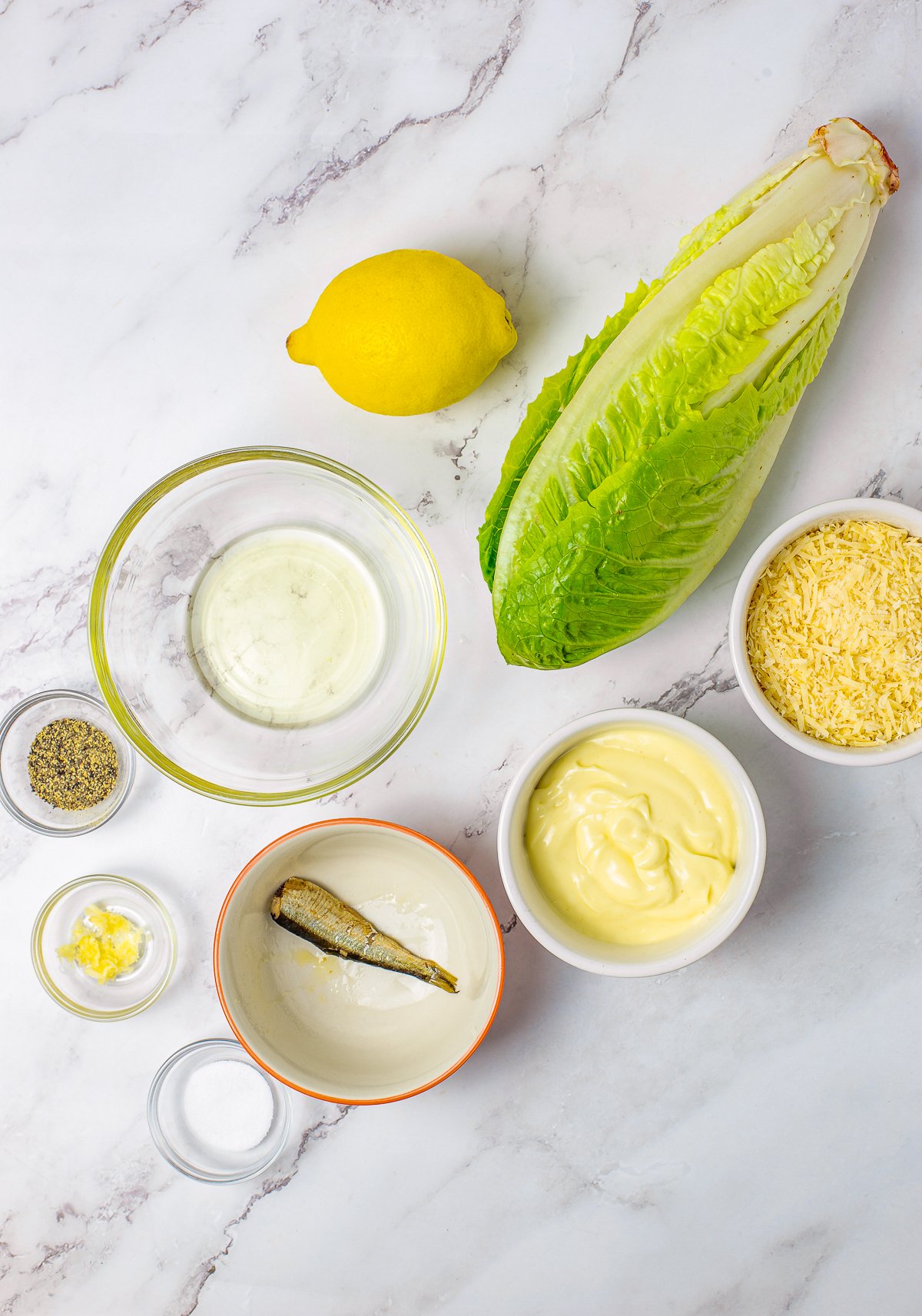 Ingredients needed to make Homemade Caesar Salad Dressing.