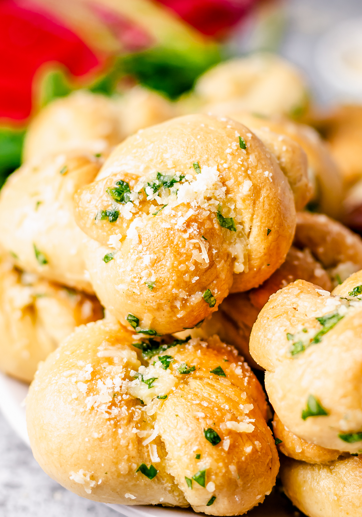 Stacked Garlic Knots Recipe close up showing butter and cheese.