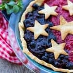 A Mixed Berry Pie with blueberry and raspberry filling topped with pie crust stars.