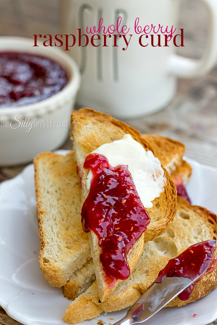 Whole Berry Raspberry Curd, sweet and tart this condiment is made with fresh raspberries and is the perfect ingredient for pastry fillings or just smeared on your morning toast! - ThisSillyGirlsLife.com #curd #raspberrycurd #summerrecipes #berries