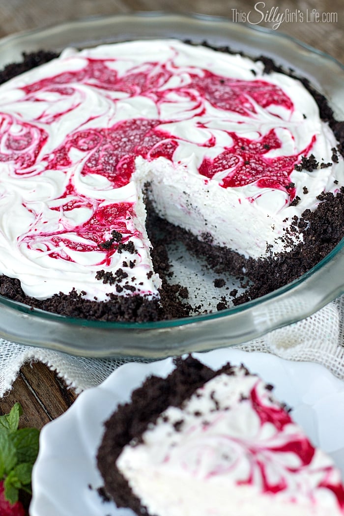 No Bake White Chocolate Raspberry Cheesecake, a frozen, decadent version of a classic cheesecake. With Oreo cookie crust! - ThisSillyGirlsLife.com #OreoCrust #WhiteChocolateRaspberryCheesecake #Cheesecake #NoBake #NoBakeCheesecake