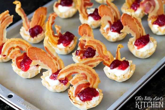 Creamy Cranberry Pancetta Bites, flavored goat cheese in phyllo cups with whole berry cranberry sauce and crispy pancetta! from ThisSillyGirlsLife.com #thanksgiving