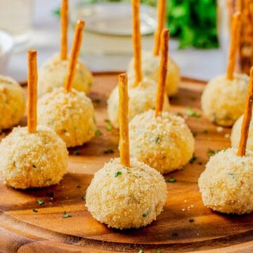 Square image of Cheese Balls with pretzels in the top.