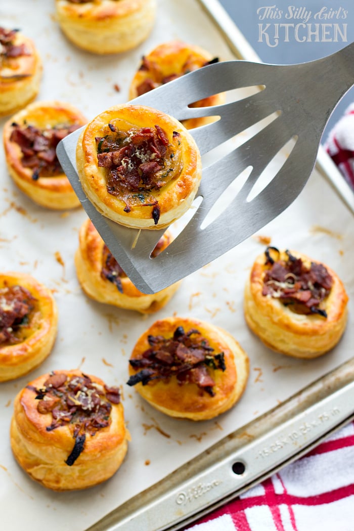 Caramelized Onion Bacon Tarts, sweet onions, salty bacon, herbs and Parmesan cheese atop puffed pastry make this an easy and elegant appetizer! from ThisSillyGirlsLife.com #caramelizedonion #bacon
