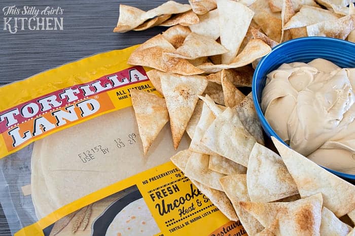 Creamy cookie butter dip in a blue bowl with cinnamon sugar tortilla chips and flour tortillas.