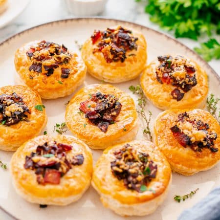 Plate of Onion Tarts with parsley in background.